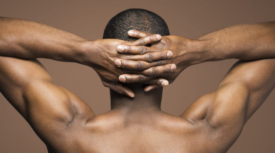 A man with his hands behind his head